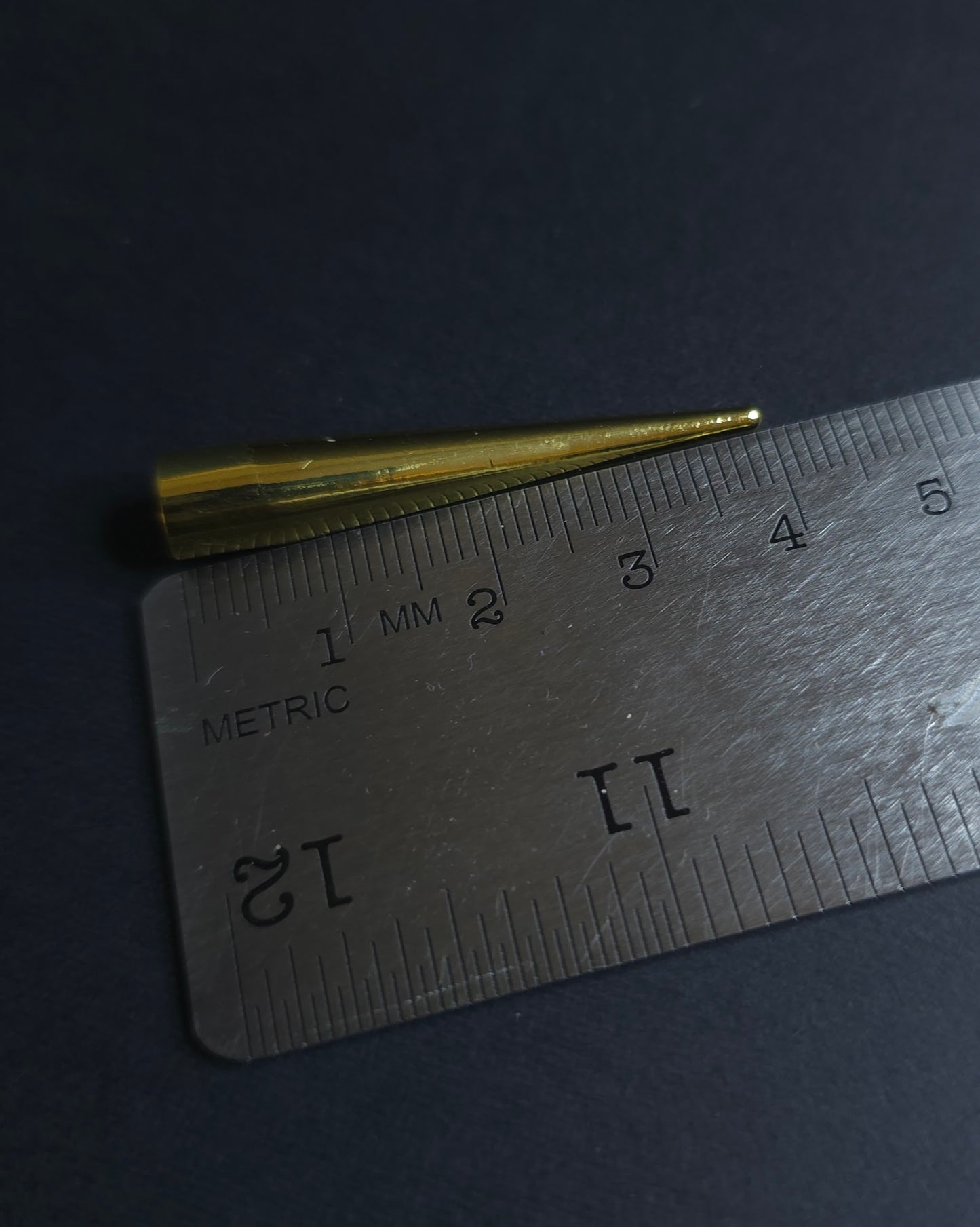 gold spike on ruler