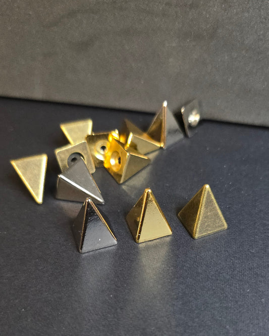 multi colored pyramid spikes on black background