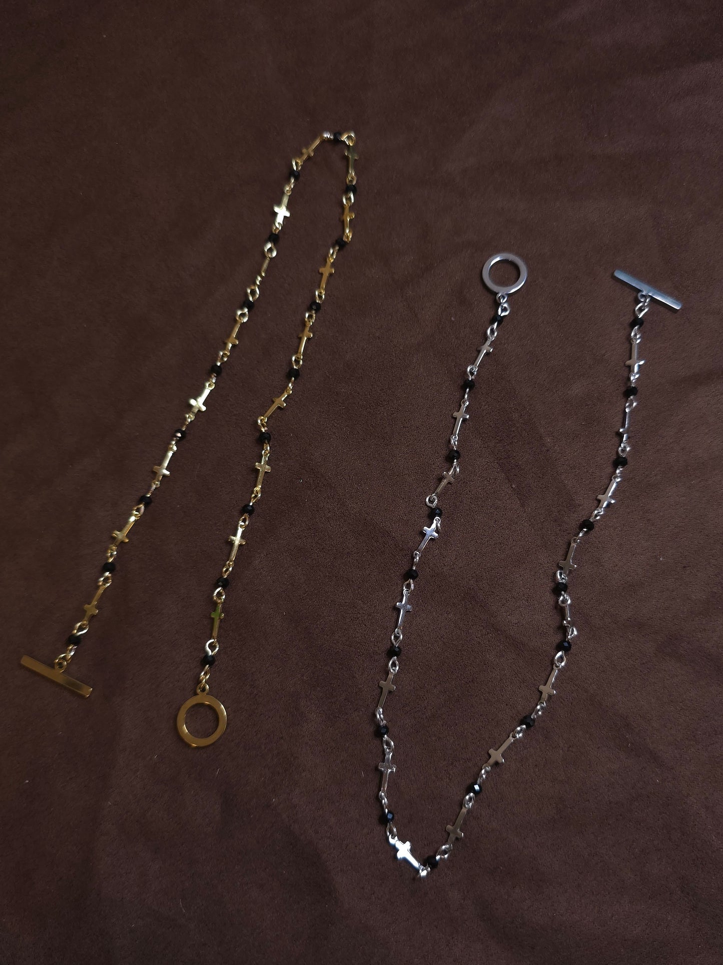 Two necklaces on a brown surface