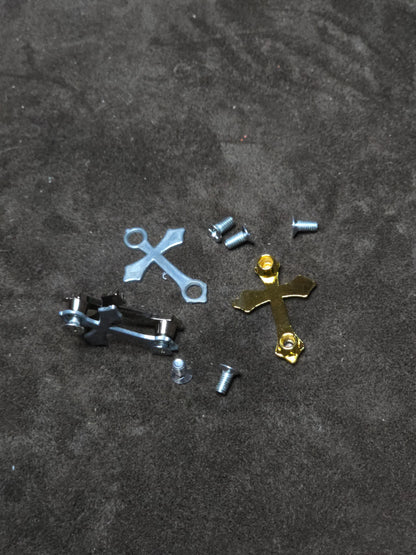Metallic cross-shaped objects on a textured dark surface