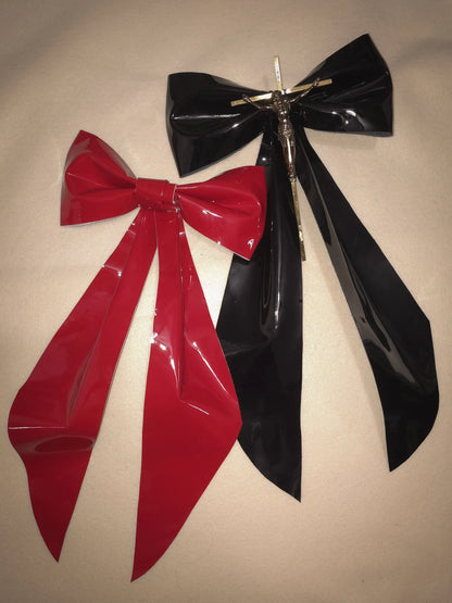 black and red large patent leather bows on cream background