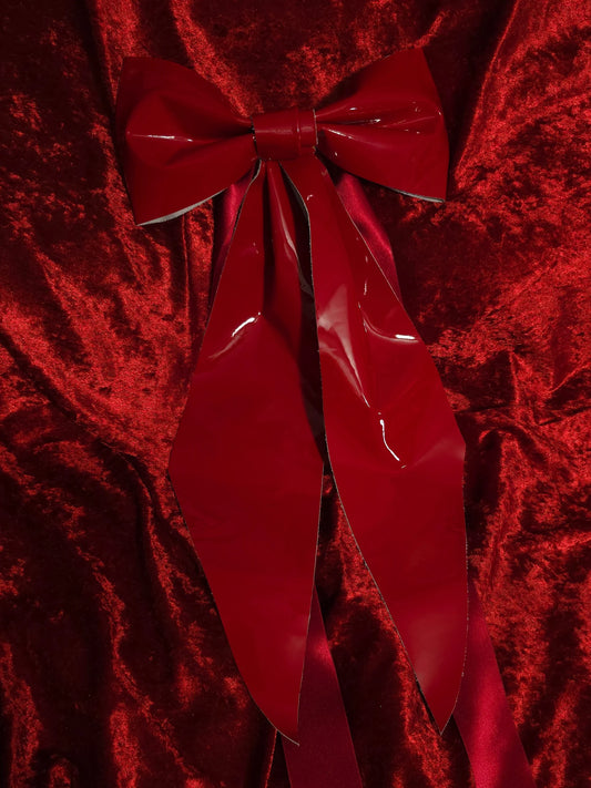 Red bow on a red textured fabric background