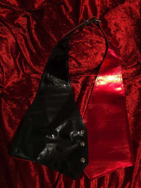 Black and red shiny vest on red velvet background