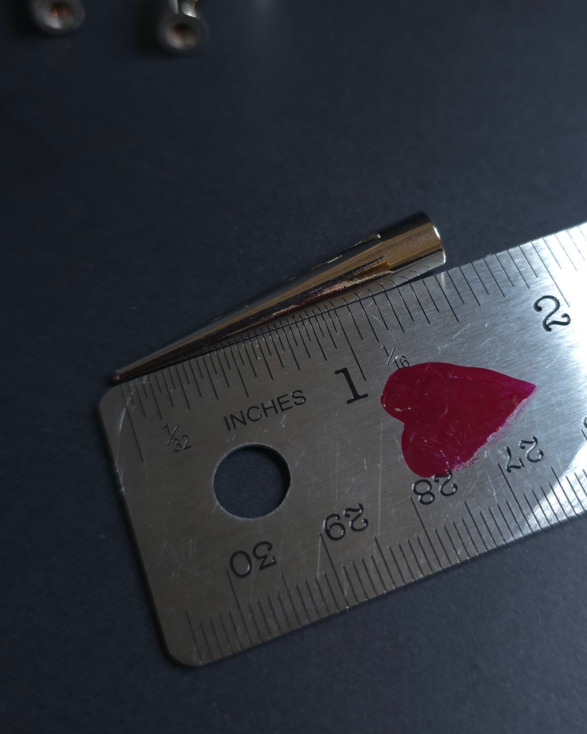 silver spike on a ruler