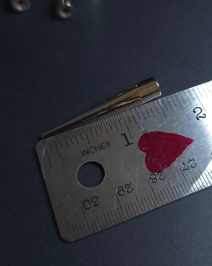 silver spike on a ruler