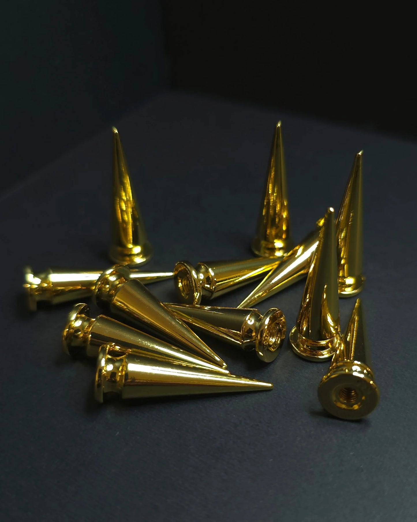 Gold metallic cones on a dark background