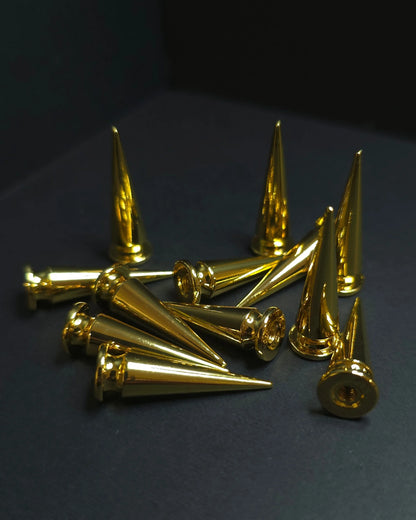 Gold metallic cones on a dark background