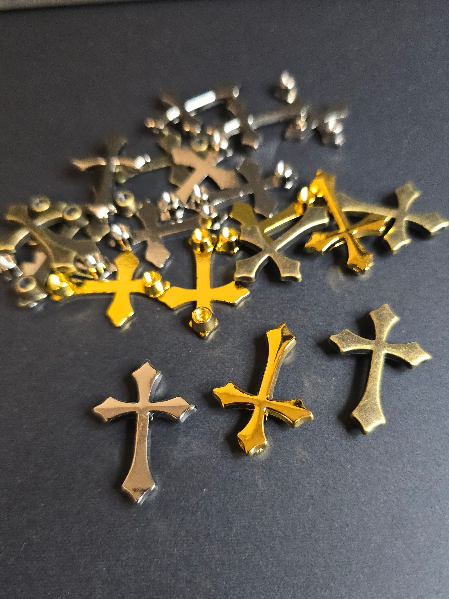 multi colored metal crosses on black background