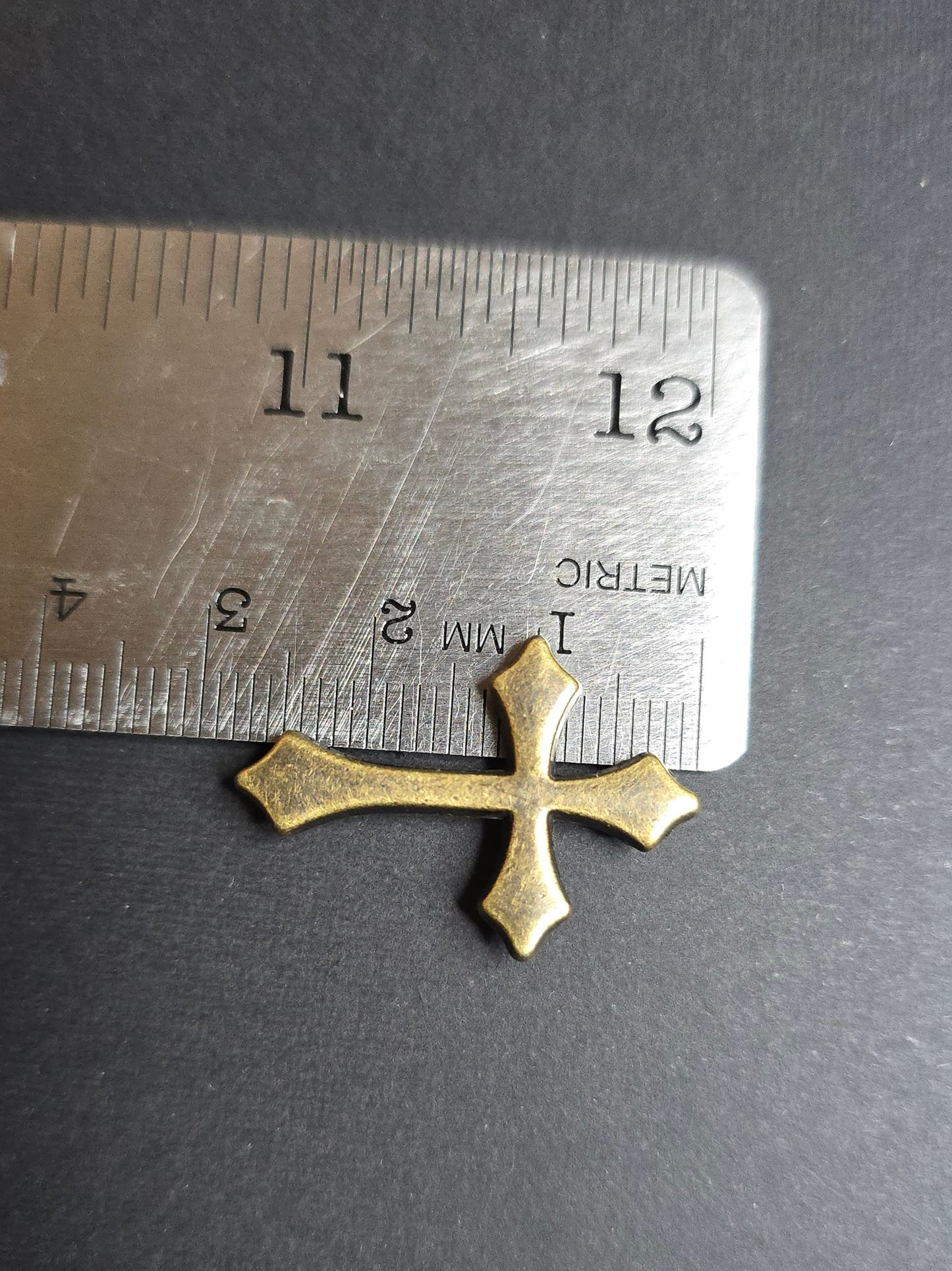 bronze cross on ruler