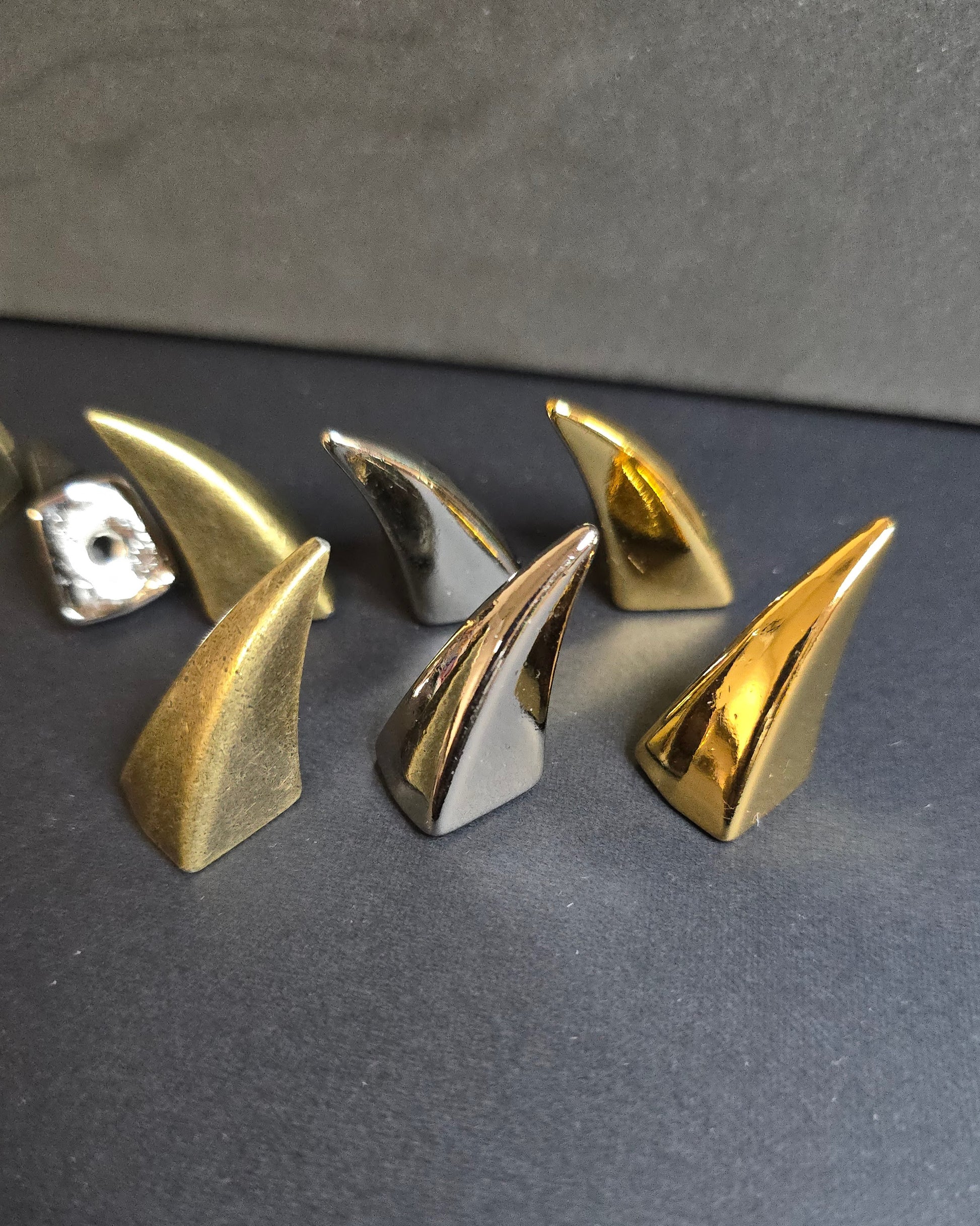multi colored claw shaped spikes on black background