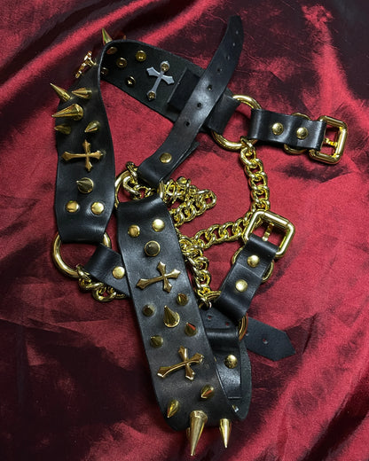 black leather shoe belts laid on a red backg