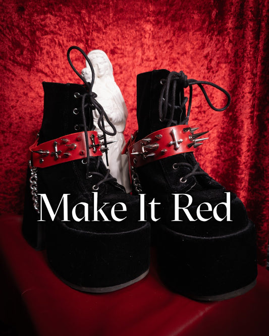 black boots with red and silver leather belt with the words "make it red"