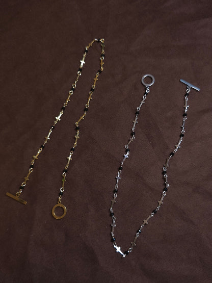 Two necklaces on a brown surface